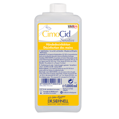 Ένα ορθογώνιο μπουκάλι 1 λίτρου Dr. Schnell CIMOCID SENSITIVE απολύμανσης χεριών της DR.SCHNELL GmbH & Co. KGaA με γερμανικές και γαλλικές οδηγίες χρήσης σε λευκή-κίτρινη ετικέτα και λευκό καπάκι για αποτελεσματική μείωση μικροβίων.