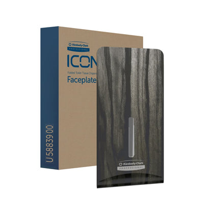 Ένα καφέ κουτί με την επιγραφή "Kimberly-Clark Professional™ Icon™ Dispenser Faceplate - FTT" στέκεται δίπλα σε μια σκοτεινή, ξύλινη πρόσοψη (27,80 x 13,10 x 1,40 cm) με το λογότυπο της Kimberly-Clark GmbH - ιδανική για σύγχρονο σχέδιο τουαλέτας.
