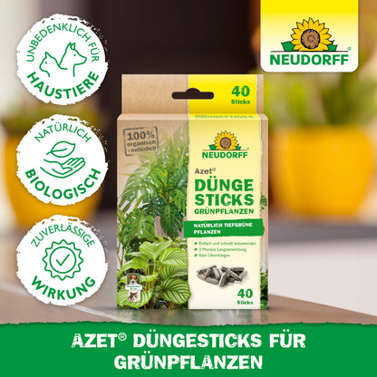 Abgebildet ist eine Packung Neudorff Shop Azet Düngesticks für Grünpflanzen mit den Angaben 40 Sticks, Nährstoffdepot, Tierschutz, natürliche Inhaltsstoffe und zuverlässige Wirkung. Das Bild zeigt grüne Blätter und Zertifizierungssymbole.