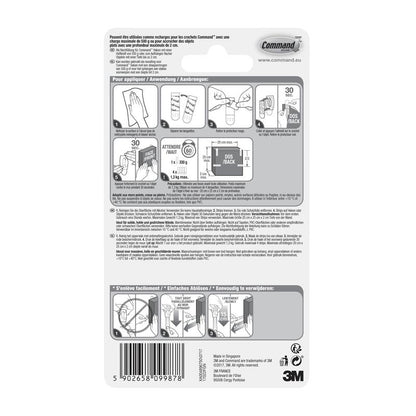 Στην πίσω πλευρά μιας συσκευασίας της 3M Deutschland GmbH Kleine Command™ Strips S, 17022N υπάρχουν εικονογραφημένες, πολυγλωσσικές οδηγίες για την εφαρμογή και αφαίρεση των αυτοκόλλητων λωρίδων χωρίς καρφιά, για να διατηρούνται οι τοίχοι χωρίς ζημιές, καθώς και ένας γραμμωτός κώδικας στο κάτω μέρος.