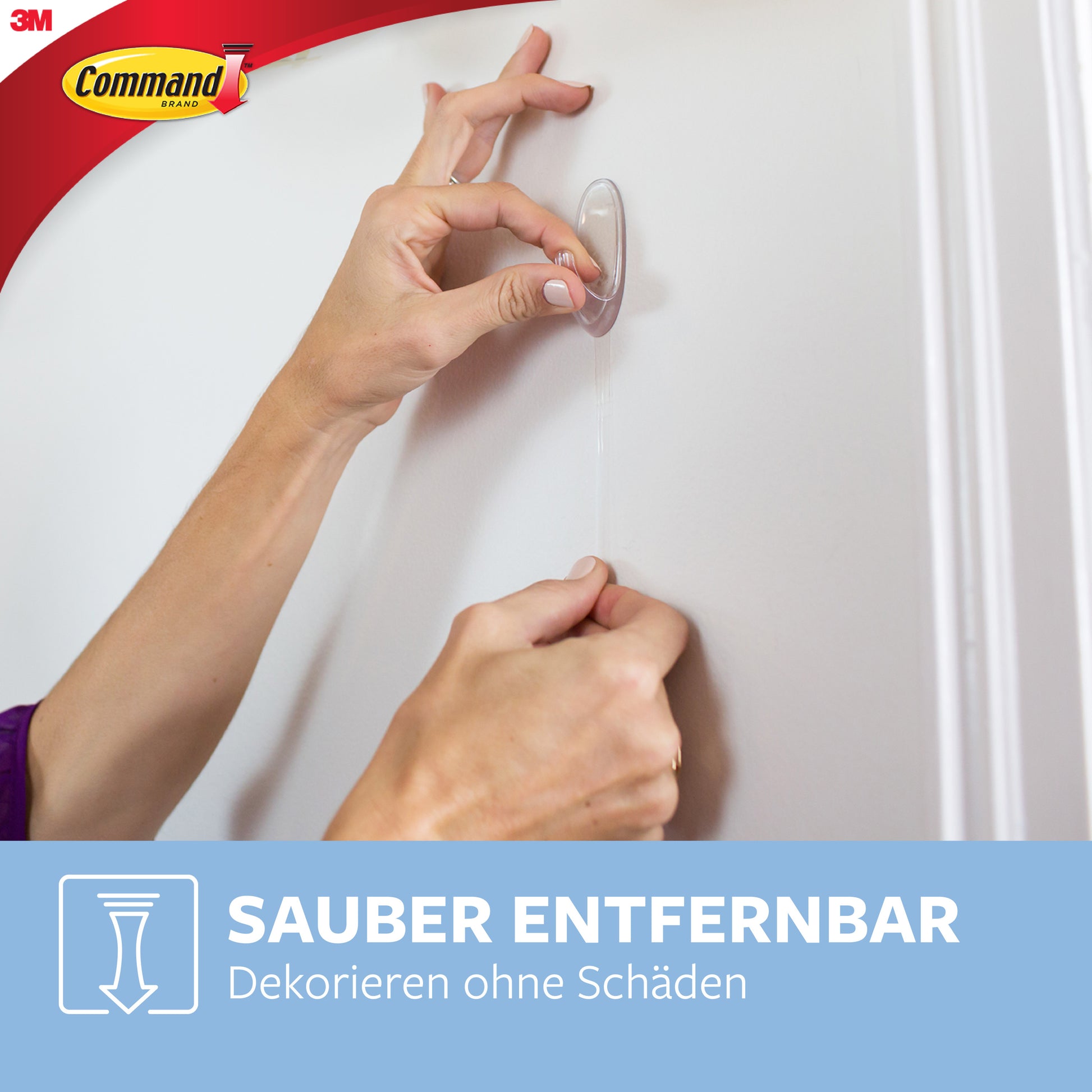 Eine Person zieht einen transparenten Command™ Haken M, mittelgroß, 17091CLR von 3M Deutschland GmbH von einer weißen Wand ab. Die Command und 3M Logos sind oben links. Unten steht: "Sauber entfernbar. Dekorieren ohne Schäden.