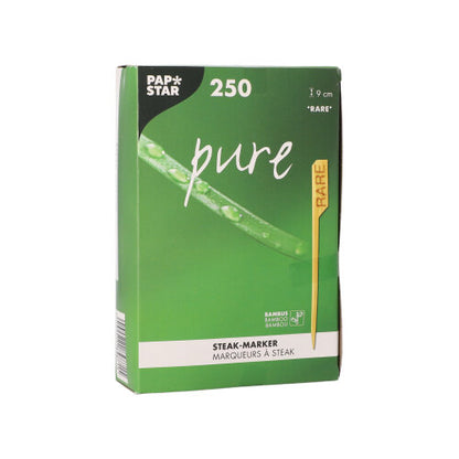Ο PAPSTAR 250 δείκτης μπριζόλας 9 εκ. της PAPSTAR GmbH παραδίδεται σε ένα πράσινο-λευκό κουτί. Η συσκευασία περιέχει έναν κίτρινο δείκτη «RARE» καθώς και γραφικά φύλλων και σταγόνων νερού, σχεδιασμένα για επαγγελματικές κουζίνες εστιατορίων.