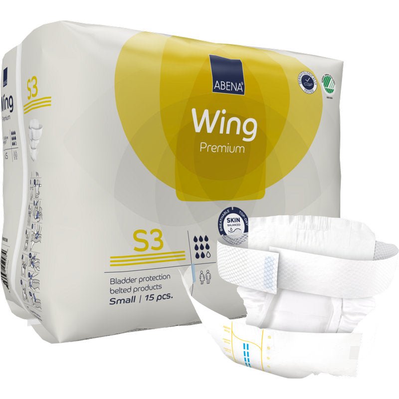 Μια όρθια συσκευασία ABENA Wing Premium της Abena Re-Seller GmbH παρουσιάζεται με μια ζώνη πάνας μπροστά. Η συσκευασία περιέχει 15 μικρά κομμάτια που προσφέρουν προστασία και άνεση για αξιόπιστη προστασία της ουροδόχου κύστης.