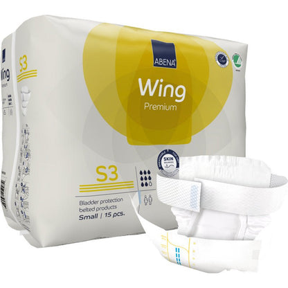 Μια όρθια συσκευασία ABENA Wing Premium της Abena Re-Seller GmbH παρουσιάζεται με μια ζώνη πάνας μπροστά. Η συσκευασία περιέχει 15 μικρά κομμάτια που προσφέρουν προστασία και άνεση για αξιόπιστη προστασία της ουροδόχου κύστης.