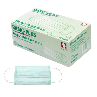Απεικονίζεται ένα κουτί AMPri BASIC-PLUS OP Maske 3-lagig. Typ II με την επιγραφή «πράσινο, 50 τεμάχια». Στο κουτί φαίνεται καθαρά η εικόνα μιας μάσκας προσώπου. Κάτω από το κουτί βρίσκεται επίπεδα μια πράσινη τριών στρώσεων μάσκα προσώπου. Η μάσκα διαθέτει λαστιχένια ταινία χωρίς λάτεξ και κατασκευάζεται από την AMPri Handelsgesellschaft mbH.