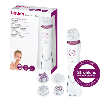 Η εικόνα δείχνει ένα συσκευασμένο Beurer FC 95 βούρτσα προσώπου Pureo Deep Cleansing Set από την Beurer GmbH. Το σετ περιλαμβάνει τη βασική συσκευή για τη βούρτσα προσώπου, τρία διαφορετικά κεφαλές βούρτσας, κατάλληλες για κάθε τύπο δέρματος, και μια μικρή μωβ στρογγυλή ταμπέλα που επισημαίνει τη βαθιά καθαριστική δράση της φροντίδας και του καθαρισμού του προσώπου.
