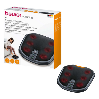 Η εικόνα δείχνει τη συσκευή Shiatsu ποδιών και πλάτης Beurer FM 70 και τονίζει τη λειτουργία θερμότητας που μπορεί να ενεργοποιηθεί. Η μαύρη συσκευή διαθέτει ορατούς κόκκινους κόμβους μασάζ και πολλά κουμπιά ελέγχου. Η συσκευασία περιλαμβάνει μια φωτογραφία ενός ατόμου που απολαμβάνει το μασάζ ποδιών και πλάτης, καθώς και λεπτομέρειες προϊόντος σε πολλές γλώσσες.