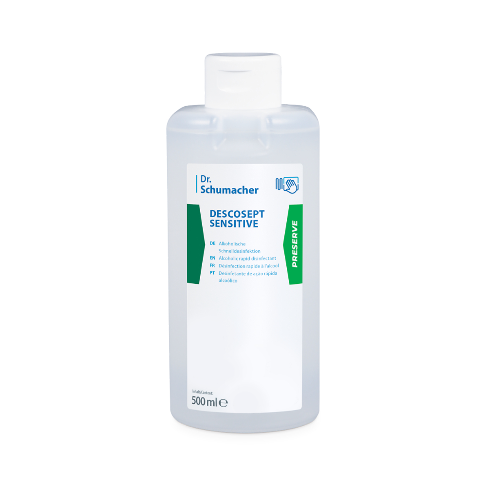 Ένα μπουκάλι 500 ml Dr. Schumacher Descosept Sensitive Schnelldesinfektion της Dr. Schumacher GmbH, σχεδιασμένο για την απολύμανση ιατρικών προϊόντων. Το διαφανές μπουκάλι διαθέτει μια λευκή ετικέτα με το όνομα του προϊόντος και οδηγίες χρήσης σε πολλές γλώσσες, συμπεριλαμβανομένων των Αγγλικών, Γερμανικών και Γαλλικών, καθώς και μια πράσινη ετικέτα «Preserve» στο πλάι.