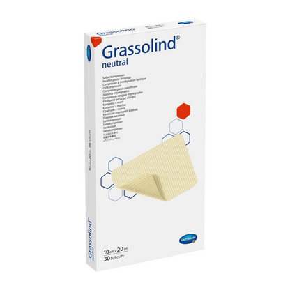 Ένα κουτί Hartmann Grassolind® αλοιφή συμπίεσης, διάφορα μεγέθη, ιατρικός επίδεσμος τραυμάτων, με σημαντικές πληροφορίες προϊόντος και μια απεικόνιση της αλοιφής συμπίεσης στο μπροστινό μέρος. Η συσκευασία είναι κυρίως λευκή.