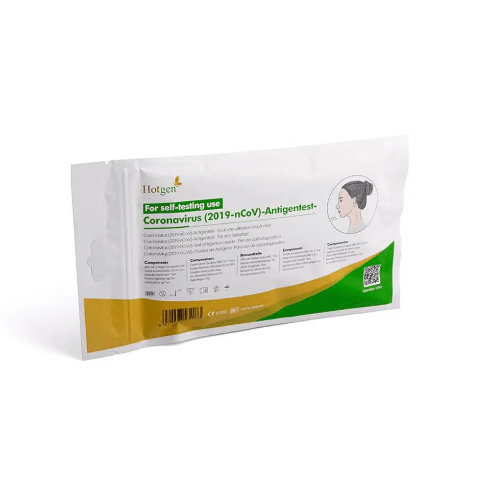 Μια συσκευασία με την επιγραφή „Hotgen Sars-CoV-2 Antigen Laien Schnelltest CE0123 | Συσκευασία (1 τεστ)“ για αυτοέλεγχο έχει πράσινες και πορτοκαλί αποχρώσεις και δείχνει μια απεικόνιση ενός ατόμου. Η επιγραφή „Hotgen“ είναι εμφανής στην επάνω αριστερή γωνία και χαρακτηρίζει το τεστ ως αντιγονικό τεστ για τον SARS-CoV-2.
