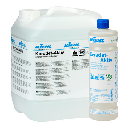 Δύο δοχεία Kiehl Keradet-Aktiv Alkohol-Universal-Reiniger της Johannes Kiehl KG: ένα δοχείο 10L και ένα μπουκάλι 1L, και τα δύο με μπλε/μαύρα γράμματα σε λευκές ετικέτες. Ιδανικό για τον καθαρισμό όλων των επιφανειών.