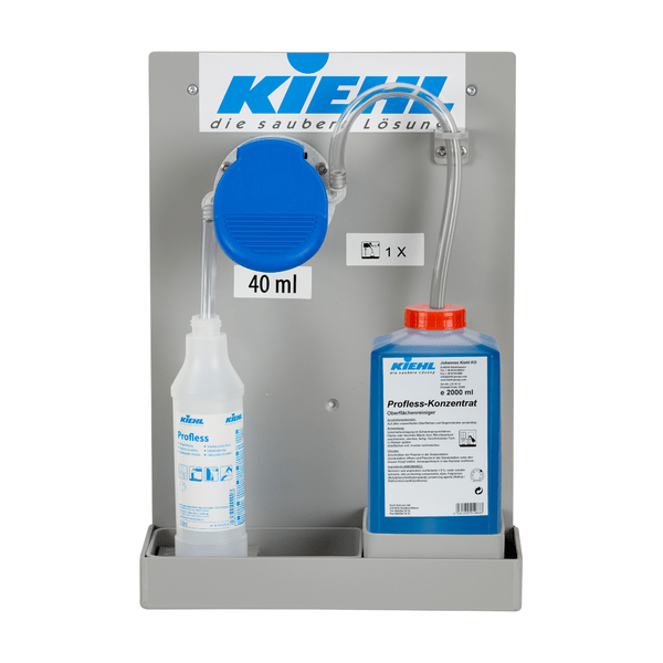 Μια αντλία Johannes Kiehl KG Kiehl-DosiExpress 25 ml τοποθετημένη στον τοίχο για Desinet-compact συμπύκνωμα ή Blutoxol, με διαφανή σωλήνα, ένα μπουκάλι 1L "Profess" και ένα μπλε μπουκάλι 2L "Profess-Konzentrat" ή Desinet-compact.