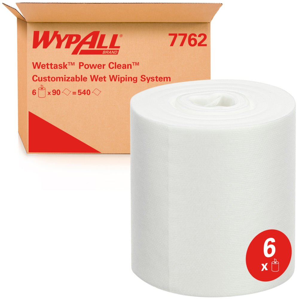 Ένας μεγάλος ρόλος υφασμάτων καθαρισμού WypAll® Wettask™ από την Kimberly-Clark GmbH στέκεται μπροστά από ένα κουτί με την επιγραφή "6 ρόλοι x 90 φύλλα / κουτί", που αναφέρεται σε έξι απορροφητικούς ρόλους αναπλήρωσης.