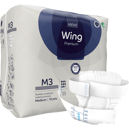 Μια συσκευασία ABENA Wing Premium ενηλίκων από την Abena Re-Seller GmbH, μέγεθος M3, περιέχει 15 κομμάτια. Μια πάνα απεικονίζεται μπροστά για να τονίσει το σχεδιασμό της και τις λωρίδες για άριστη προστασία και άνεση. Η συσκευασία δείχνει πληροφορίες προϊόντος και μάρκας.
