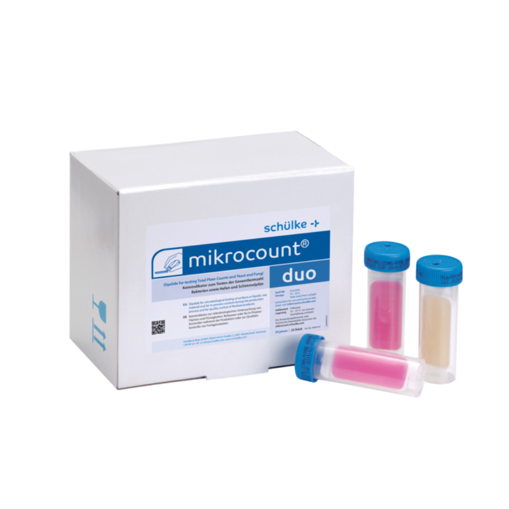 Η εικόνα δείχνει ένα κουτί με την επιγραφή „Schülke mikrocount® duo, δείκτης μικροβίων | Πακέτο (20 τεμάχια)“ της μάρκας „Schülke & Mayr GmbH“ δίπλα σε τρεις σωλήνες με καπάκια μπλε χρώματος. Οι σωλήνες περιέχουν ροζ και μπεζ ουσίες, που χρησιμοποιούνται για την ανίχνευση μικροοργανισμών σε επιφάνειες και υγρά, συμπεριλαμβανομένων ζυμομυκήτων και μούχλας.